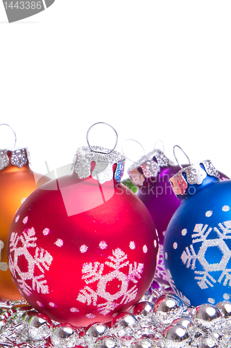 Image of christmas balls with snowflake symbols