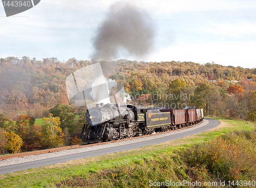 Image of WM Steam train powers along railway