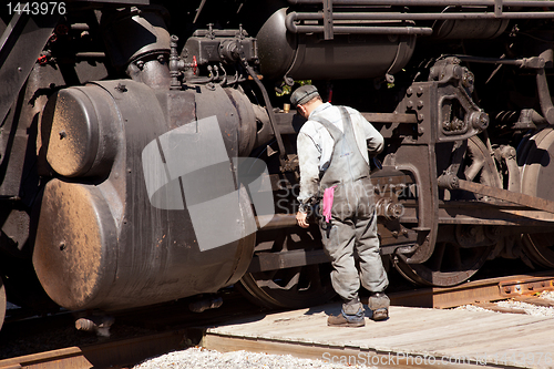 Image of Mechanic checks locomotive