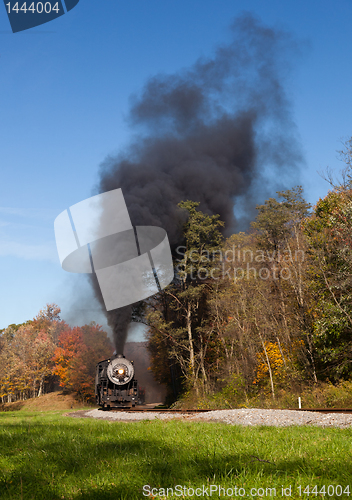 Image of Steam train powers along railway