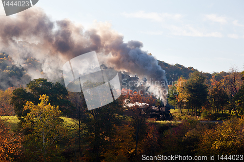 Image of Steam train powers along railway