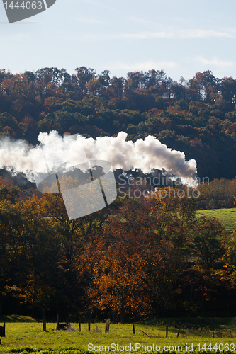 Image of Steam train powers along railway