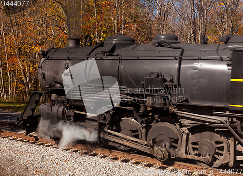 Image of Steam train powers along railway