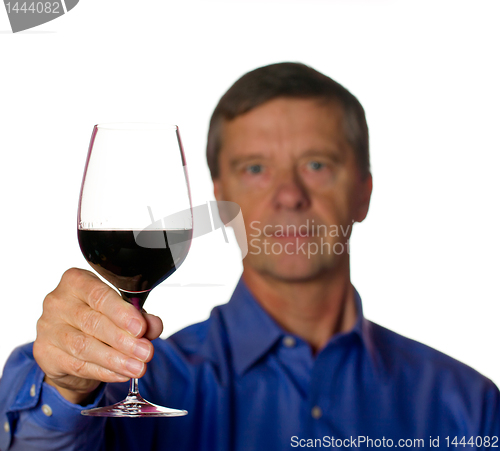 Image of Senior man with glass of red wine