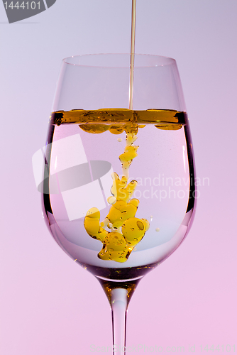 Image of Olive oil being poured into wine glass