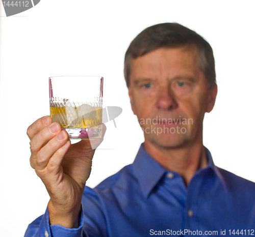Image of Senior man with glass of whisky