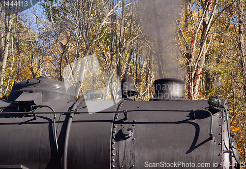 Image of Steam train powers along railway