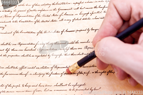 Image of Closeup of Hand Pencil Erasing First Amendment to U.S. Constitut