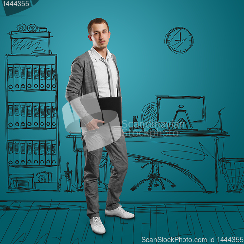 Image of male in with laptop in his hands