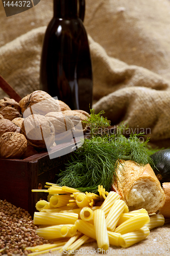 Image of still life with chest, nuts, pumpkin, bread 