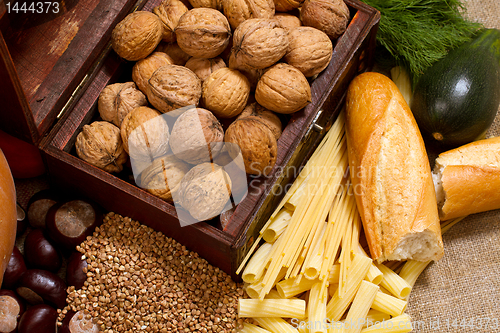 Image of still life with chest, nuts, pumpkin, bread 