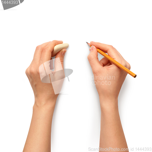 Image of human hands with pencil and erase rubber