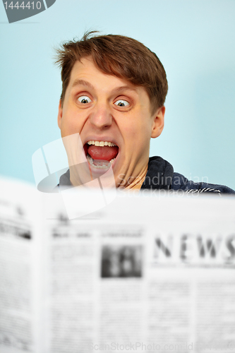 Image of Man shocked - bad news from newspaper