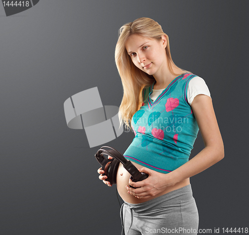 Image of pregnant female with headphones