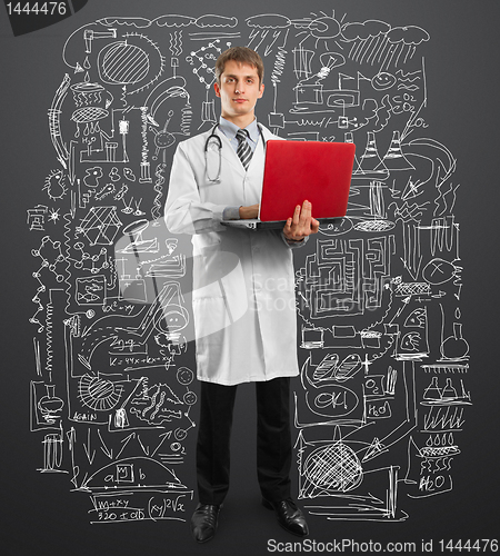 Image of doctor male in suit with laptop in his hands