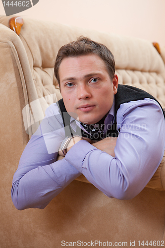 Image of Portrait of a man lying on a sofa