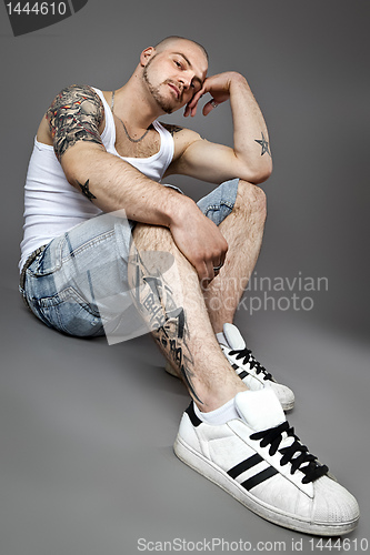Image of man with tattoos
