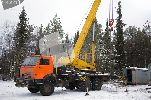 Image of crane working in the woods in winter