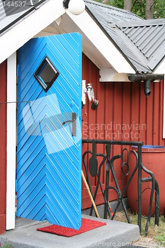 Image of Blue door, red house