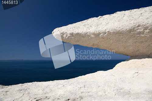 Image of eroded chalk rock white stone blue sky and sea