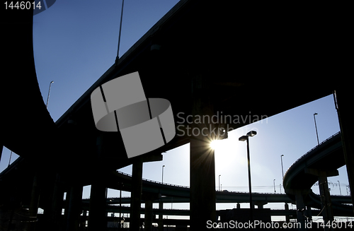 Image of Highway ramps in silhouette with sun burst