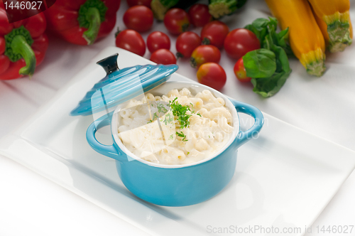 Image of mac and cheese on a blue little clay pot