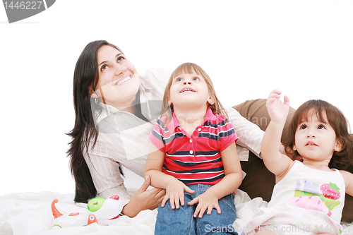 Image of Happy caucasian mother and two daughter playing and looking up