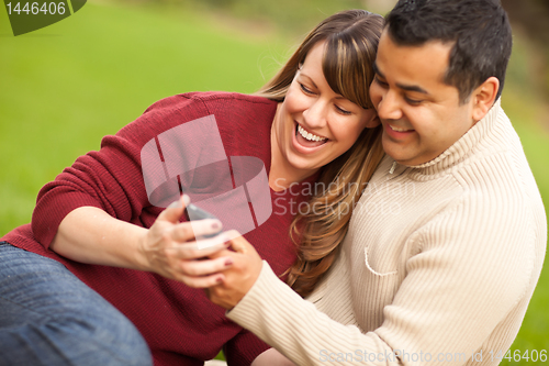 Image of Attractive Mixed Race Couple Enjoying Their Camera Phone