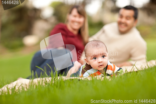 Image of Happy Baby Boy and Mixed Race Parents Playing in the Park