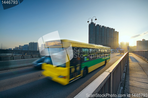 Image of speed bus through sunset road