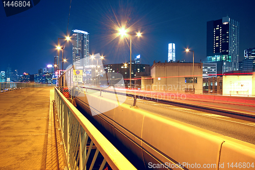 Image of pedestrian overpass and traffic bridge at night