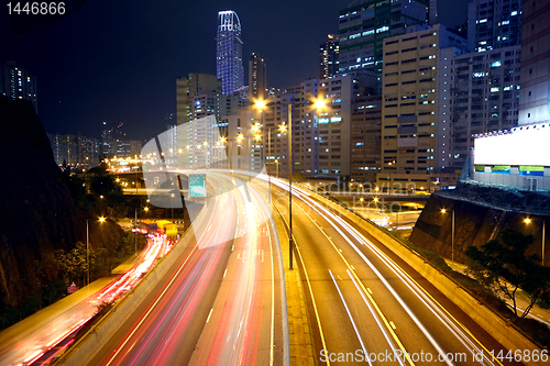 Image of urban area dusk, busy traffic 