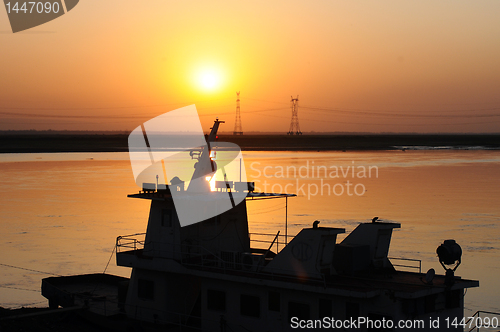 Image of Silhouette of a ship at sunset