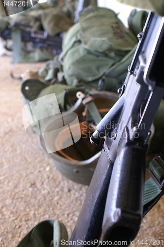 Image of a rifle and a soldier helmet