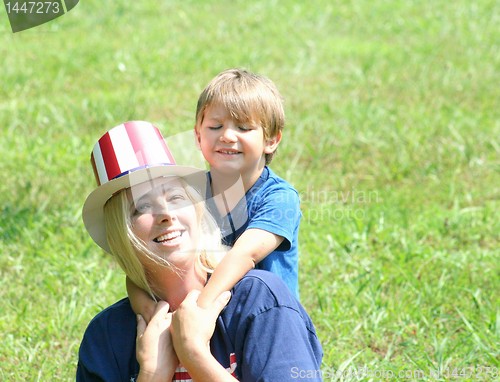 Image of  Young mother and baby in 4th of july hats