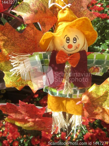 Image of Halloween scarecrow on bale of hay