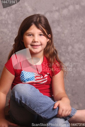 Image of young girl in jeans and red shirt