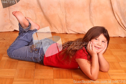 Image of little girl lying on floor 