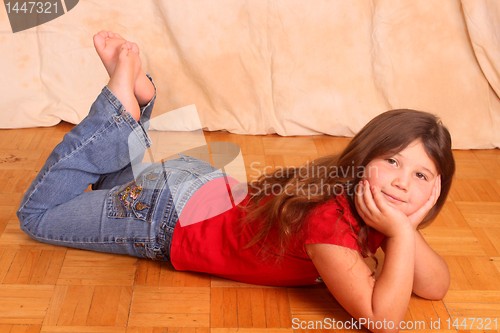 Image of little girl lying on floor 