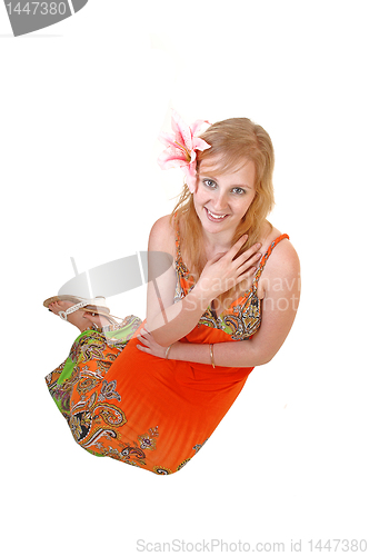 Image of Lovely teen girl sitting on floor.