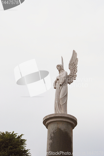 Image of White angel with elevated wings 