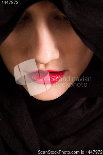 Image of Girl looking down with black hood