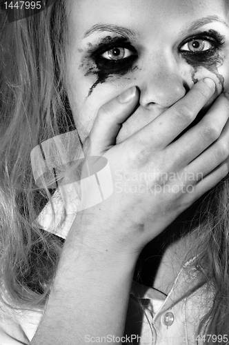 Image of A depressed young girl covering her mouth