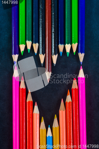 Image of Colorful pencils on dark background in a shape of a heart