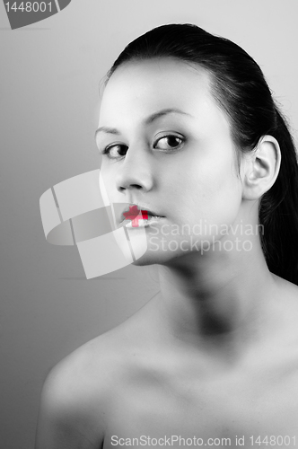 Image of Black and white ohoto of a girl with medical lipstick