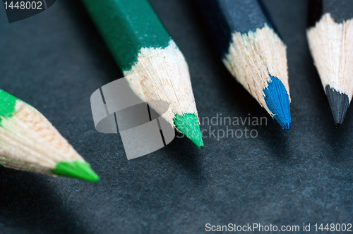 Image of Colorful pencils on dark background lined up