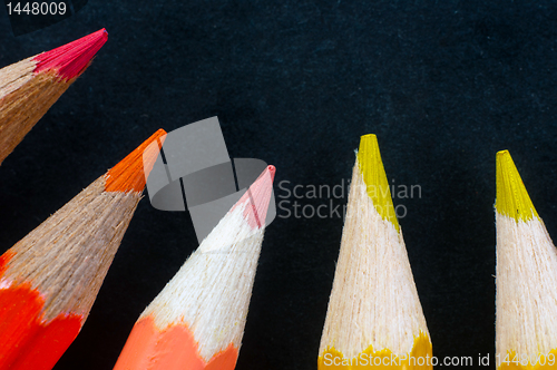 Image of Colorful pencils on dark background lined up