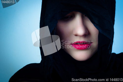 Image of Girl in black hood against blue background