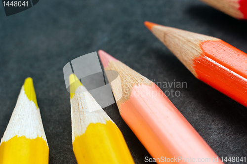 Image of Colorful pencils on dark background lined up