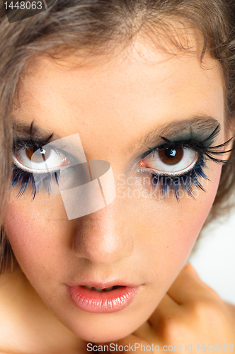Image of young beautiful girl with extreme makeup on white isolated backg